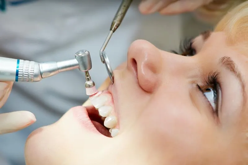 Hygienist cleaning a patient’s teeth